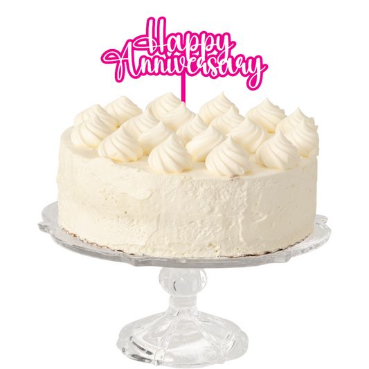 Cake topper with the words: Happy Anniversary in pink on a white cake. Cake topper can be made in different colours. 