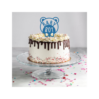 Teddy bear in a bow tie with the words 'Baby Boy' on a cake